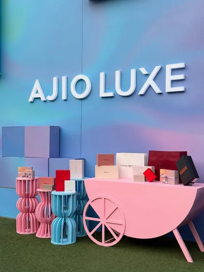 The Ajio Luxe branding stands out against the dreamy, airbrushed background. This setup was designed to attract attention and provide a perfect photo opportunity for guests at the luxury weekend event.