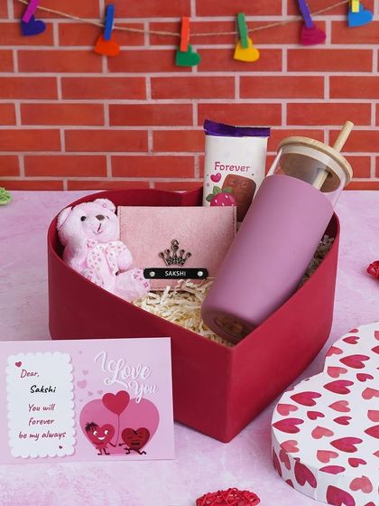 A closer look at the Love Keepsake Hamper, showing the personalized mini wallet and borosilicate glass tumbler. You can choose the name and charm for the wallet.
