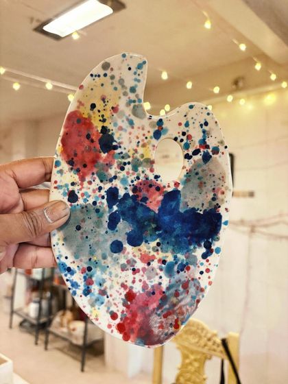 This artist's palette, with its chaotic and colorful splatter glaze, perfectly captures the playful spirit of experimentation. It was made by a beginner student finding her style.