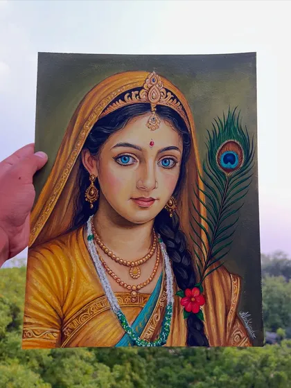 Another angle of the completed Radha painting, held against a natural background to highlight the colors.