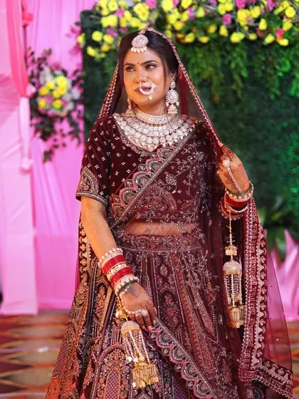 Kalpana looked like royalty in her deep red lehenga. We paired it with a soft glam look that felt grand yet graceful.