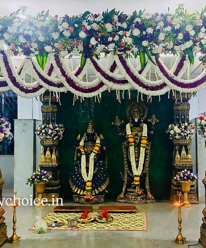A magnificent floral mandap created for a muhurtham ceremony in front of the deities. The design uses traditional pillars and garlands for a temple-like feel.