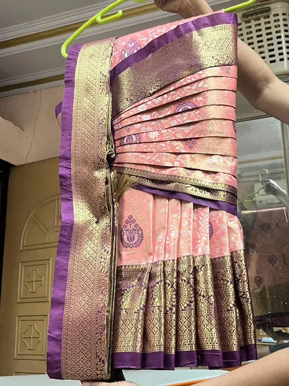 A pre-pleated bridal Kanjivaram saree, ready for our bride. The tiny pleats are set and the saree is ready for hanger folding, making it easy to transport and wear.