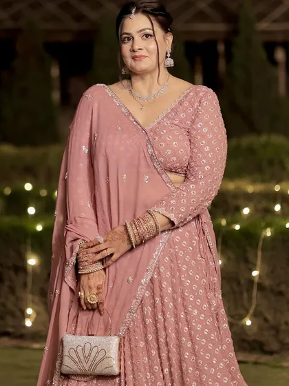 The full view of her beautiful pink party outfit. The makeup is kept timeless and elegant.