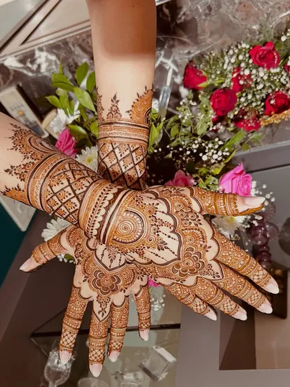 A gorgeous, full-coverage design with a mix of geometric and floral patterns. The symmetry between the two hands is just perfect.
