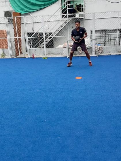 An athlete in the middle of a medicine ball throw during a lateral movement drill. This exercise adds a layer of core engagement and stability, challenging the athlete to maintain body control while generating power.