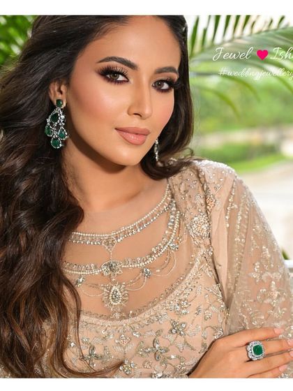 For a sophisticated reception look, I suggest statement pieces like these bold emerald and diamond earrings paired with a matching oversized ring. They add a touch of color and luxury.