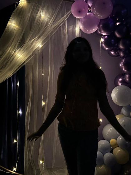 A silhouette shot of a guest posing against the fairy-lit backdrop. These kinds of artistic photos are a popular part of the experience.