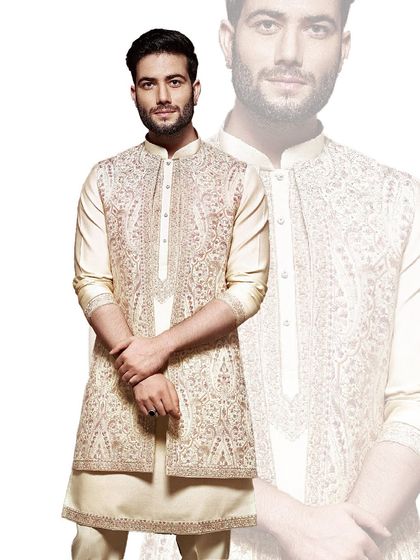 This ivory ensemble features a beautifully embroidered open jacket over a classic kurta. We designed it for celebrations that call for a blend of traditional artistry and sophisticated layering.