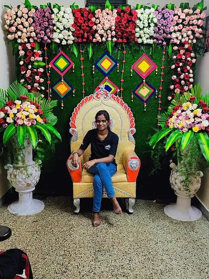 A young girl sitting on the throne in front of the colorful backdrop. It makes for a great photo opportunity.