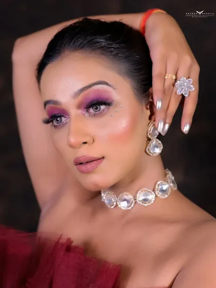 A high-fashion pose, with the model's arm raised, showcasing the drama of the gown and her confident attitude.