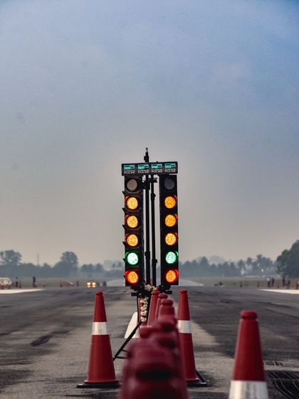 The Christmas tree lights go green, signaling the start of another explosive race. This iconic image captures the tense, split-second moment before the launch.