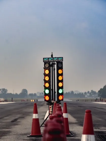 The Christmas tree lights go green, signaling the start of another explosive race. This iconic image captures the tense, split-second moment before the launch.