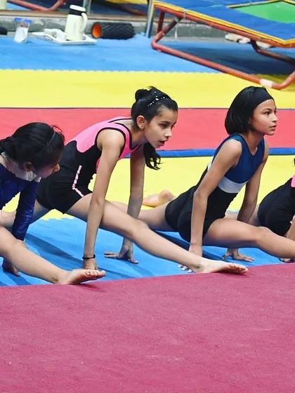 Flexibility is a cornerstone of gymnastics. Our structured stretching routines help students safely improve their range of motion, which is essential for both performance and injury prevention.