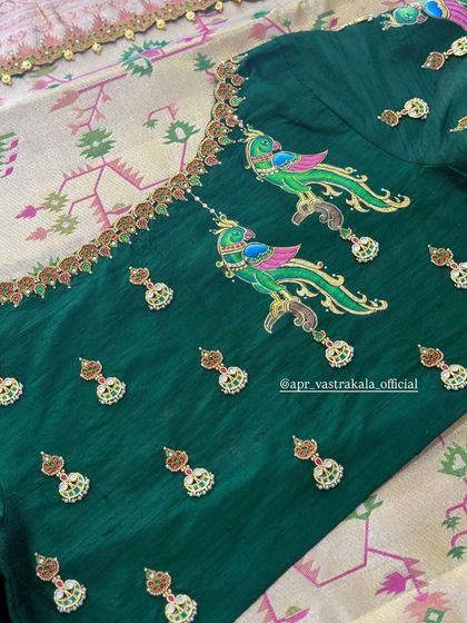 The back of the green blouse, showing the scattered painted butis that complement the main artwork on the sleeves.
