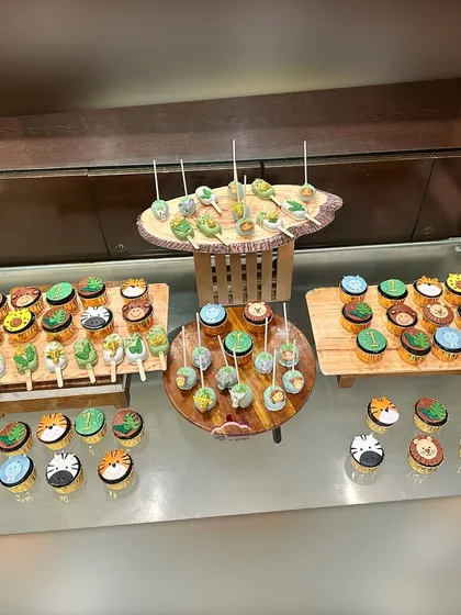 This is what I mean by a dessert table that tells a story. For this 'Wild One' first birthday, I created a full jungle experience with a variety of themed treats, including custom cupcakes, cakesicles, and cake pops, all beautifully arranged to wow the guests.