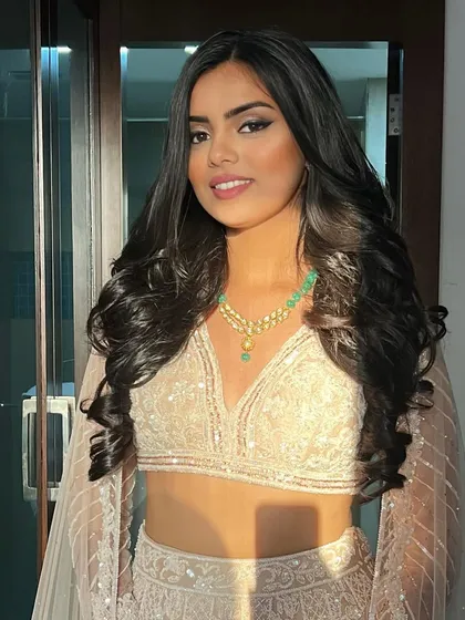 A golden hour shot of a Roka bride with voluminous, open waves.
