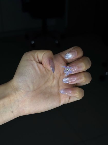 A side view of the 4D ombre nail set, showing the delicate structure of the butterfly embellishment.