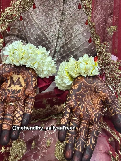 The final look for a beautiful bride, with her dark mehendi stain complemented by floral jewelry.