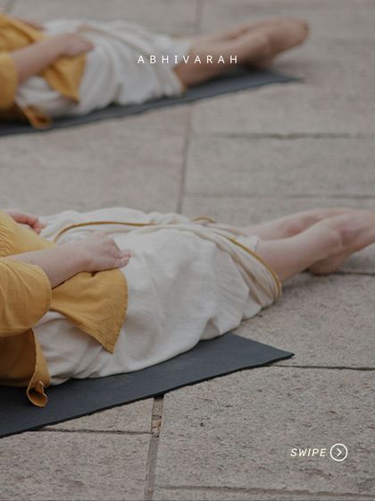 After inverted asanas, it is vital to flex the spine back to its natural state. Here, practitioners are in a preparatory stage for a counter-pose, ensuring the 33-link suspension of the spine is cared for.
