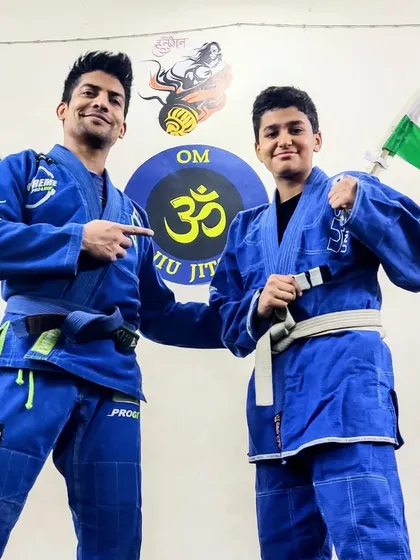 Another proud moment. Pointing to the new stripe that this student has earned through his consistent effort and hard work in our kids' Jiu-Jitsu class.