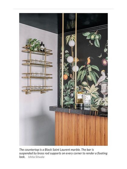 We are thrilled to be featured in Architectural Digest! This clipping showcases a bar we designed with a Black Saint Laurent marble countertop and a beautiful botanical wallpaper.