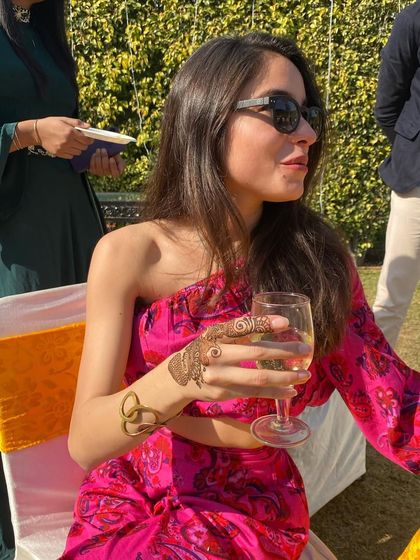 A side view of the client's minimalist finger and wrist henna, showing how it acts as a delicate accessory.