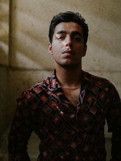 An edgier, moody shot of Gagan Arora from the same shoot, where the focus is on the cool, retro-inspired printed shirt.