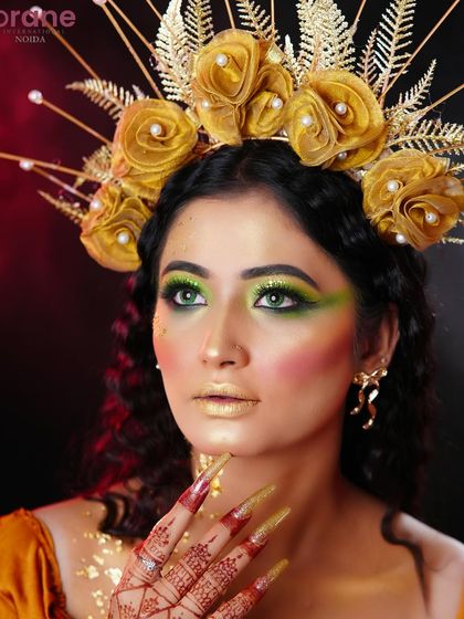 A close-up on the vibrant green and gold eye makeup, creating a striking and powerful look.