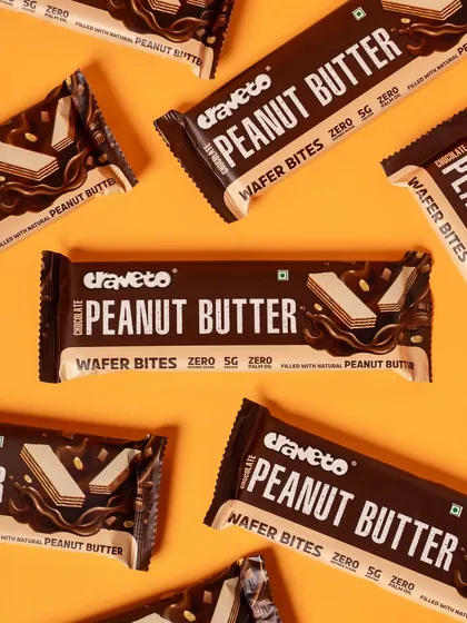 A pattern of chocolate peanut butter wafer bars on a solid orange background. The strong contrast and clean lines make the packaging design pop.