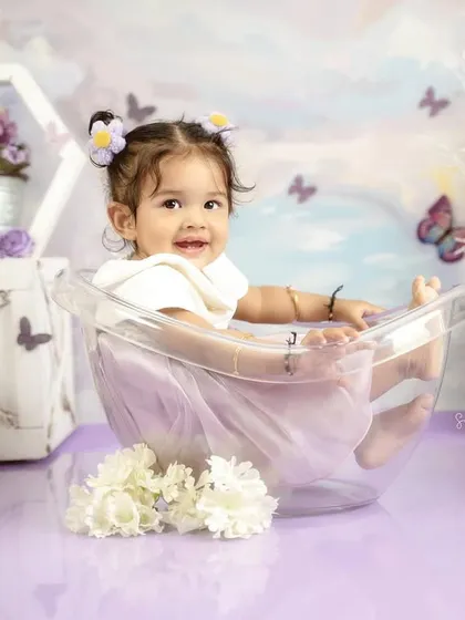 Kicking back and relaxing in the tub. This playful shot is from a butterfly-themed first birthday session.