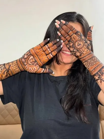A playful shot of a happy client with her intricate bridal mehndi.