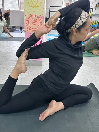 This practitioner holds a deep Mermaid Pose, her focus and alignment reflecting the dedication we nurture in our classes.