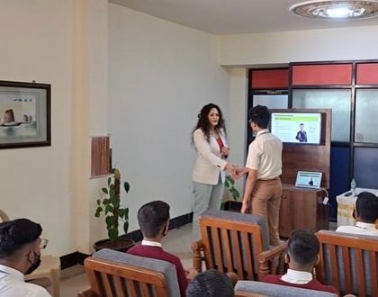 A practical demonstration of a professional handshake during my workshop with students. Mastering these small but significant details of business etiquette is crucial for making a positive first impression.