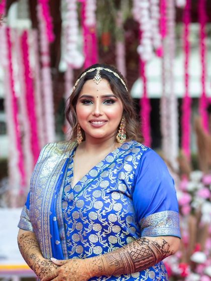 A confident and happy portrait. The makeup is glamorous yet approachable, perfect for celebrating with friends and family.