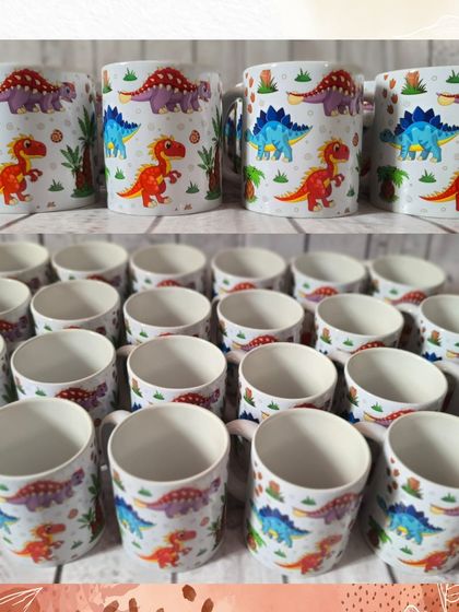 A batch of my popular dinosaur-themed mugs, featuring a variety of colorful dinosaurs. These are always a huge hit with the kids.