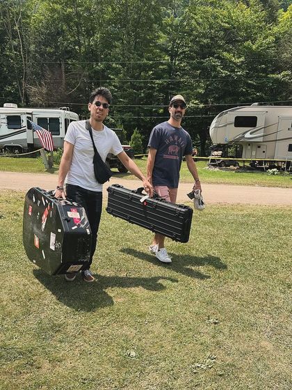 My bandmates carrying their instruments at the Jetlag Music Festival. This behind-the-scenes shot shows the dedication and teamwork that goes into every single performance.