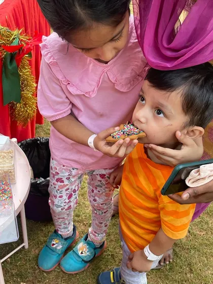 Sharing is caring. These two are enjoying a sprinkle-topped cookie at one of my events.