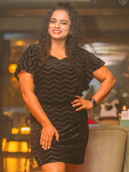 A guest posing in a stylish black dress.