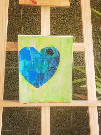 This heart, with its cool blues and greens, is for a love that brings peace and tranquility. I used a palette knife to create blocky textures, suggesting the feeling of being grounded and calm. It rests on my easel, ready to find its home.