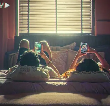 A screengrab from the Valentine's film, showing a modern couple in a relaxed, everyday setting. The styling here is casual and relatable, reflecting the film's theme of authentic love.