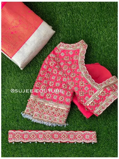 A complete set featuring a bright pink blouse with all-over floral embroidery in silver and gold. The set includes a matching embroidered vaddanam (belt) to complete the look.