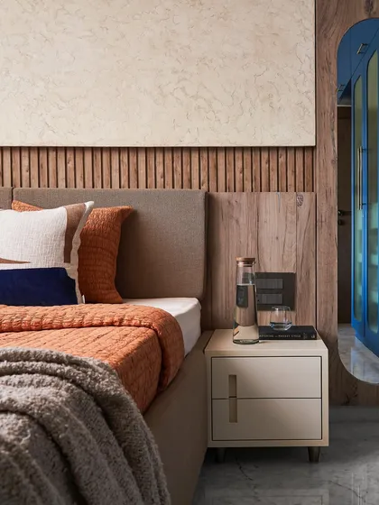 Another view of the guest room's bedside, highlighting the neutral tones and natural materials used in the design.