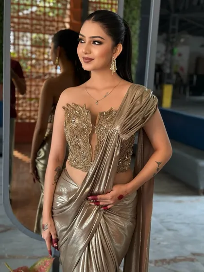 Another angle of the golden saree look, showing its unique draping.