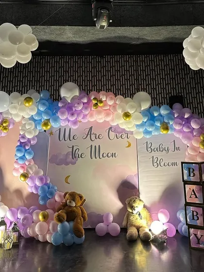 The complete "Over the Moon" baby shower backdrop. We included cute teddy bears, "BABY" blocks, and balloon clouds hanging from the ceiling to make the theme come alive.