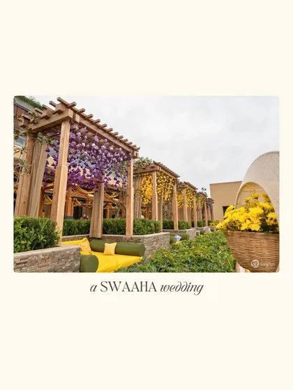 Rows of cabanas draped in purple and yellow flowers, creating beautiful and intimate seating areas for guests.