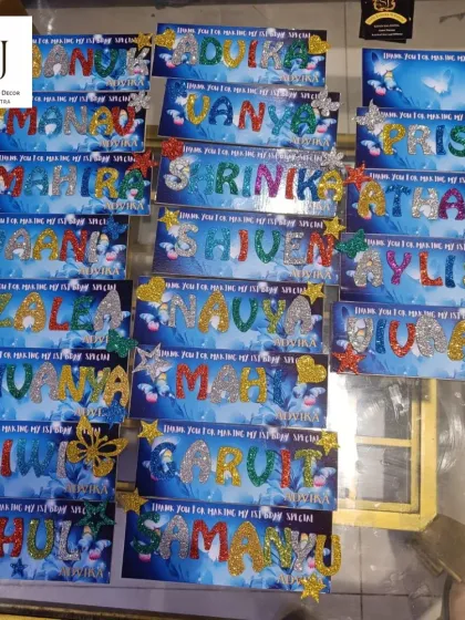 A personalized nameplate making activity at a butterfly-themed party. This is a wonderful return gift idea where kids get to create their own souvenir.