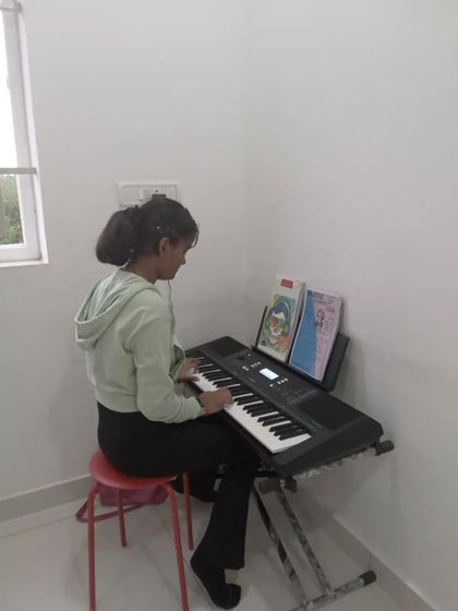 A student practicing her keyboard piece.