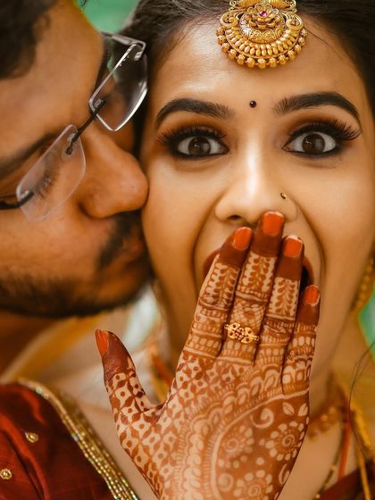 A fun and expressive close-up of the bride showing off her engagement ring.