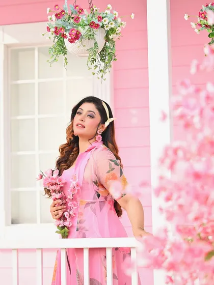Another portrait from the pink porch, this time with a focus on the model's expression. The soft light and floral elements create a beautiful and feminine image.
